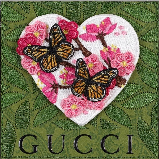 Embroidered heart of pink cherry blossoms and monarch butterflies on green Gucci fabric by Stephen Wilson